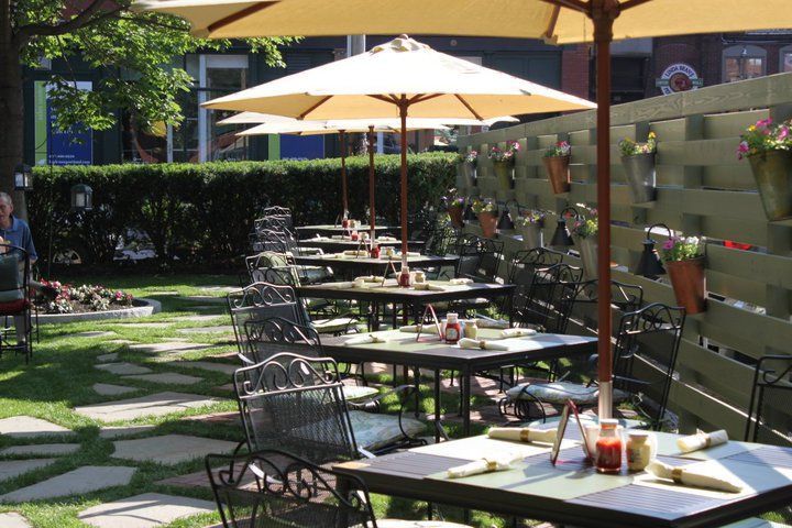 Outdoor wrought iron tables and chairs with umbrellas
